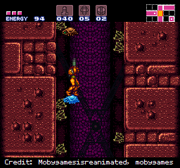 Samus stands on a frozen enemy in Super Metroid.