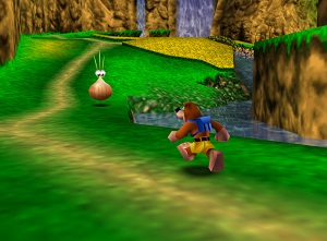 Screenshot. A lush green meadow with waterfalls.