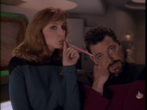Screenshot: Dr. Crusher drinks from Commander Riker's head in Data's dreams.