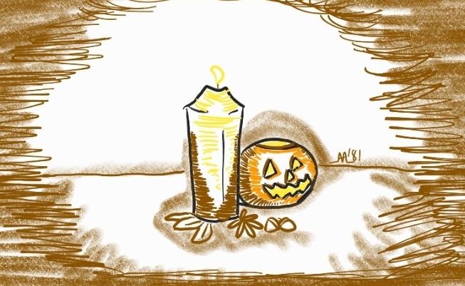 A table display with a pillar candle, miniature jack-o-lantern, leaves, and acorns.