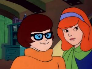 Velma and Daphne listen to a tall tale from someone.
