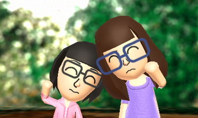 Tina and Gina posing for a camera before a backdrop.