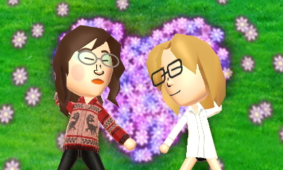 Mickey and Abby lying in a flower patch. Mickey is wearing a roomy button-down shirt.