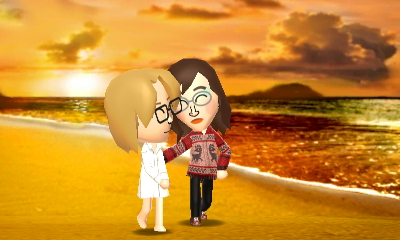 Mickey and Abby walking along the beach, Mickey still wearing his paternity shirt.